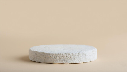 Empty round podium for product presentation, minimal pedestal. Light beige backdrop.