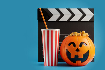 Halloween movie, popcorn in a pumpkin candy bowl with soda, october holiday celebration with horror...