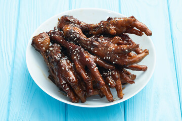 Caramelized korean or Chinese chicken foots ( paws ) with sesame . Top view