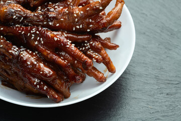 Caramelized korean or Chinese chicken foots ( paws ) with sesame . Top view