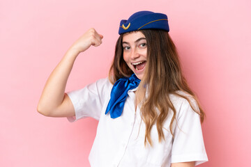 Airplane stewardess caucasian woman isolated on pink background doing strong gesture