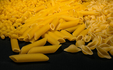 Different types and shapes of dry Italian pasta. Pasta background.
