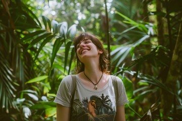 A joyful woman stands amidst lush greenery in a forest, her smile and carefree demeanor reflecting the beauty and serenity of nature.