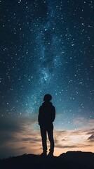 Obraz premium 39. A person standing in front of a starry night sky