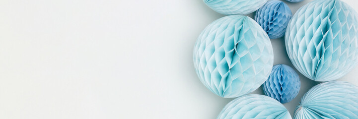 Banner with tissue paper balls on a blue background. Place for text.