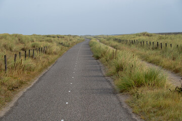 long cycle path along the dike on the dutch north sea