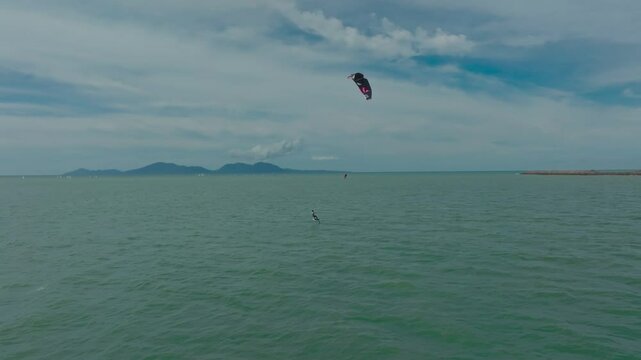 Kitesurfing in the ocean on a sunny day. Kite surfers having fun in the ocean