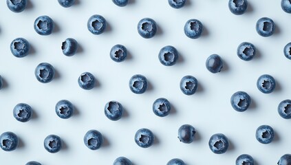 Blueberries scattered on a white background, in a seamless pattern, from a top view