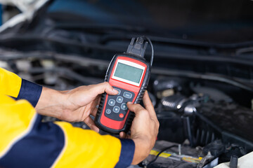 Battery inspection. Battery Capacity Tester Voltmeter. Closeup hand man professional mechanic...