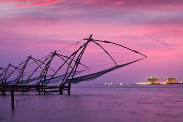 Fototapeta premium Kochi Chinese fishnets on sunset. Fort Kochin, Kochi, Kerala, India
