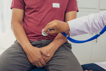A male doctor examines a patient for an enlarged prostate, a common issue in male sexual health....