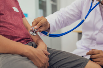 A male doctor examines a patient for an enlarged prostate, a common issue in male sexual health....