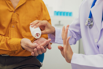 A female doctor performs a check for an enlarged prostate, evaluating male health issues such as...