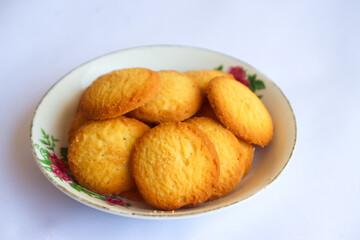 Danish butter cookies, stack of golden chocolate butter cookies isolated on white background, sweet pastry