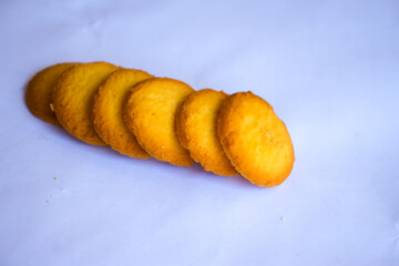 Danish butter cookies, stack of golden chocolate butter cookies isolated on white background, sweet pastry