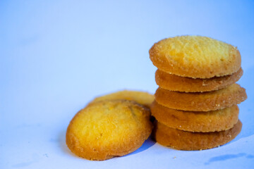 Danish butter cookies, stack of golden chocolate butter cookies isolated on white background, sweet pastry