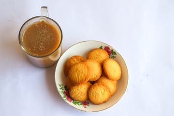 breakfast menu in the form of Danish butter cake and a glass of chocolate milk, Close up of butter cookies coated with white sugar and a glass of chocolate, sweet cake