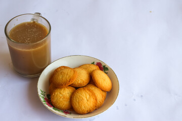 breakfast menu in the form of Danish butter cake and a glass of chocolate milk, Close up of butter cookies coated with white sugar and a glass of chocolate, sweet cake