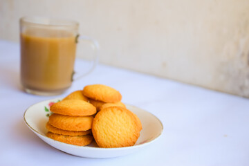 breakfast menu in the form of Danish butter cake and a glass of chocolate milk, Close up of butter cookies coated with white sugar and a glass of chocolate, sweet cake