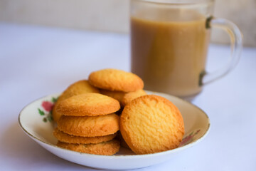 breakfast menu in the form of Danish butter cake and a glass of chocolate milk, Close up of butter cookies coated with white sugar and a glass of chocolate, sweet cake