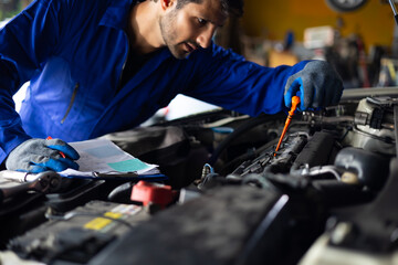 Close up hand hispanic latin male mechanic repairs car in garage. Closeup hand. Auto car mechanic...