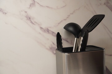 Several cooking tools such as spatulas and soup spoons are placed in their place.