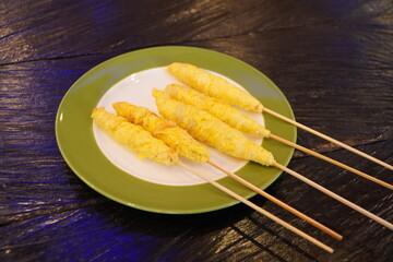 Telor gulung on a plate. Telur gulung or rolled egg is a Indonesian traditional food in which an egg is fried and then rolled using a skewer which is usually made of bamboo.