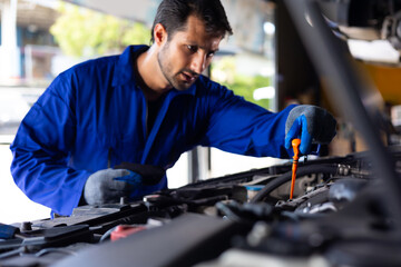 hispanic latin male mechanic repairs car in garage. Closeup hand. Auto car mechanic checking the...