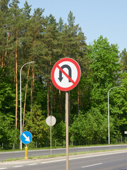 A road sign prohibiting a U-turn, prohibits the turning manoeuvre on a stretch of road, from the...