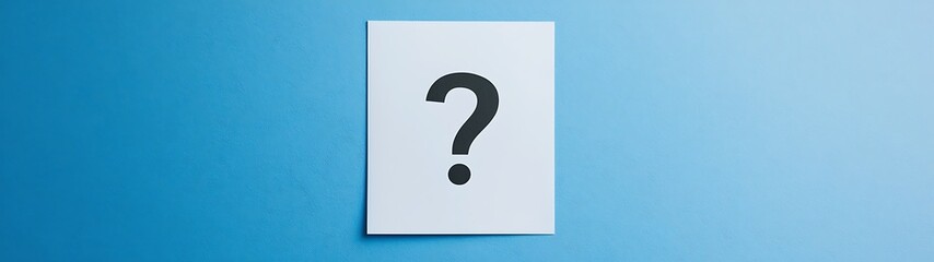 Curiosity Unveiled: Question Mark on White Paper Against Blue Background for Educational and Information Designs