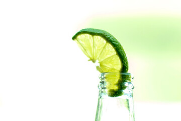 Isolated Lime in Glass Bottle: Minimalist Composition on White Background