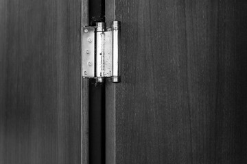 Metal Hinge on an Open Door: Wooden Background and Minimalism in Negative Space