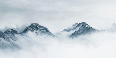 Obraz premium Misty mountains rise above the clouds, creating a serene and breathtaking landscape perfect for nature lovers and adventurers.