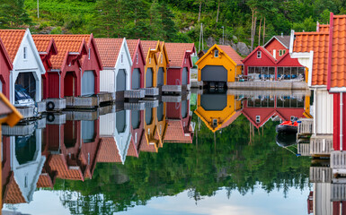 Small bay with boat houses on a calm evening.