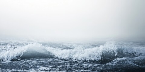 Fototapeta premium A serene view of rolling waves under a misty sky, capturing the tranquility and beauty of the ocean's surface.