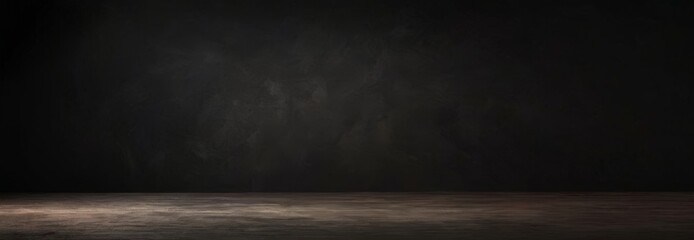 A dark, empty room with a concrete floor and a single light source on the right side, creating a dramatic and moody atmosphere.
