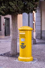 Yellow spanish post box on a village street