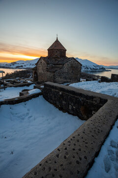 church on lake sevan at sunset in armenia