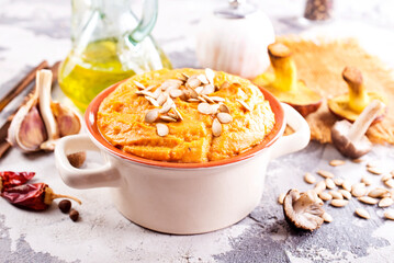 Vegetarian autumn pumpkin cream soup with mushrooms and seeds