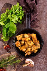 fried meat with spice in pan