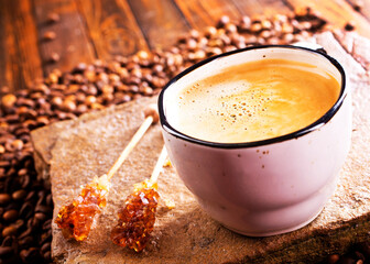 Cup of coffee on wooden background.