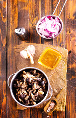 pickled mushrooms in metal bowl on the table, next to spices. pickle mushrooms