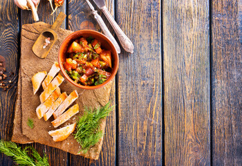 chicken fillet on board with vegetable stew in bowl
