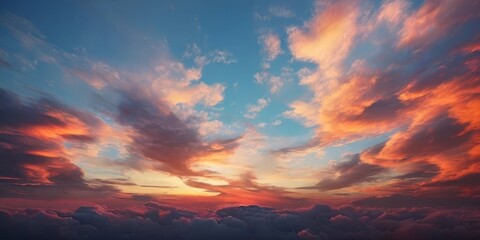 A breathtaking aerial view of a vibrant sunset sky, with a stunning display of clouds in shades of orange, pink, and blue.