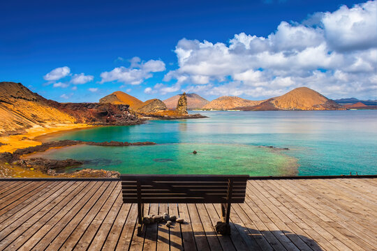 Galapagos islands. Natural landscape. Bench overlooking sea. Coast of Galapagos region. Seascape in sunny weather. Bench on wooden pier. Galapagos islands on summer day. Tourism, vacation, recreation