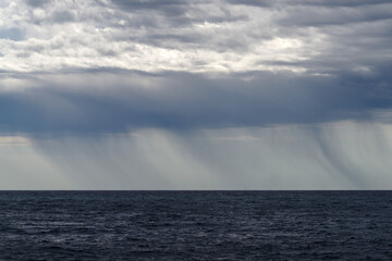 Rainstorm descends over the sea surface, Mediterranean sea, Italy