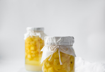 pineapple cheong in a glass jar on a white background, korean pineapple cheong in a transparent...