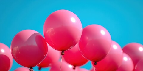 A vivid image featuring a group of bright pink balloons floating against a brilliant blue sky, capturing the essence of celebration and simplicity