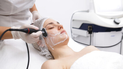 A cosmetologist performs RF lifting for facial rejuvenation and tightening. This non-invasive procedure effectively firms and smooths skin, enhancing your beauty routine.