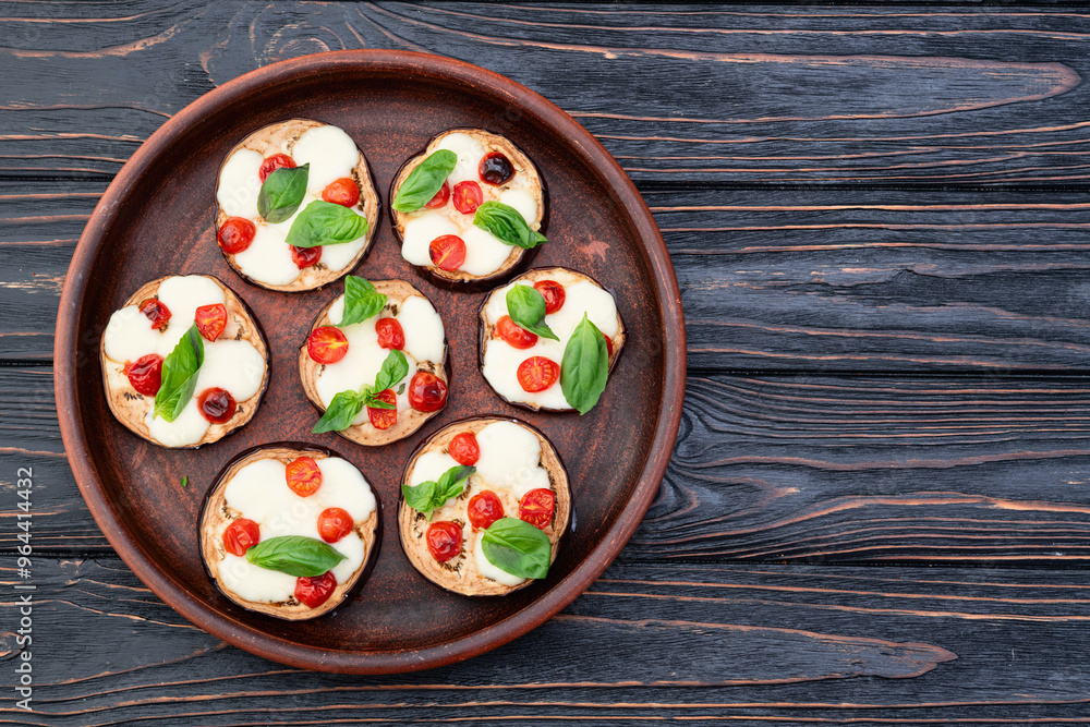 Poster italian mini pizza . aubergine (eggplant ) with mozzarella cheese and basil . on rustic background